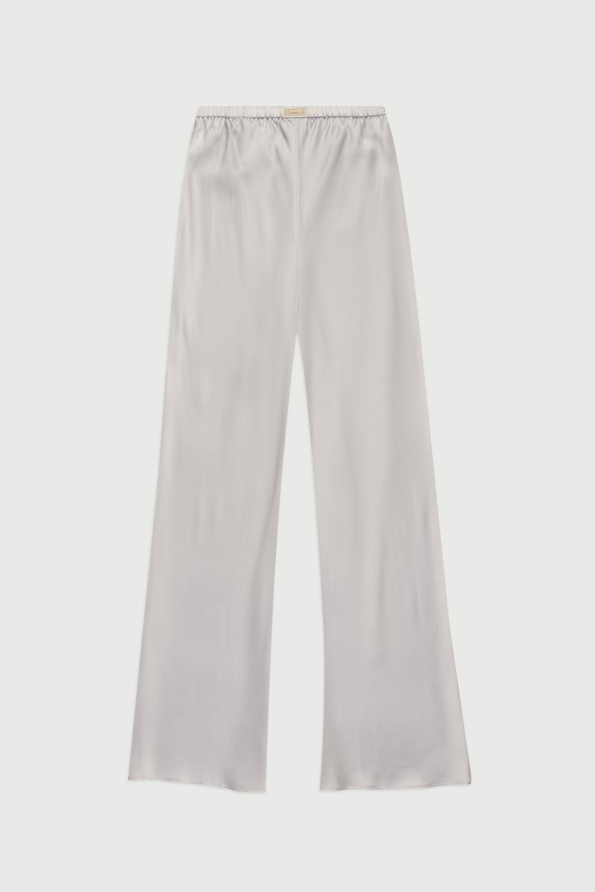 Comme Si silver bias-cut silk pants with an elastic waistband and wide legs, shown flat against a light background.