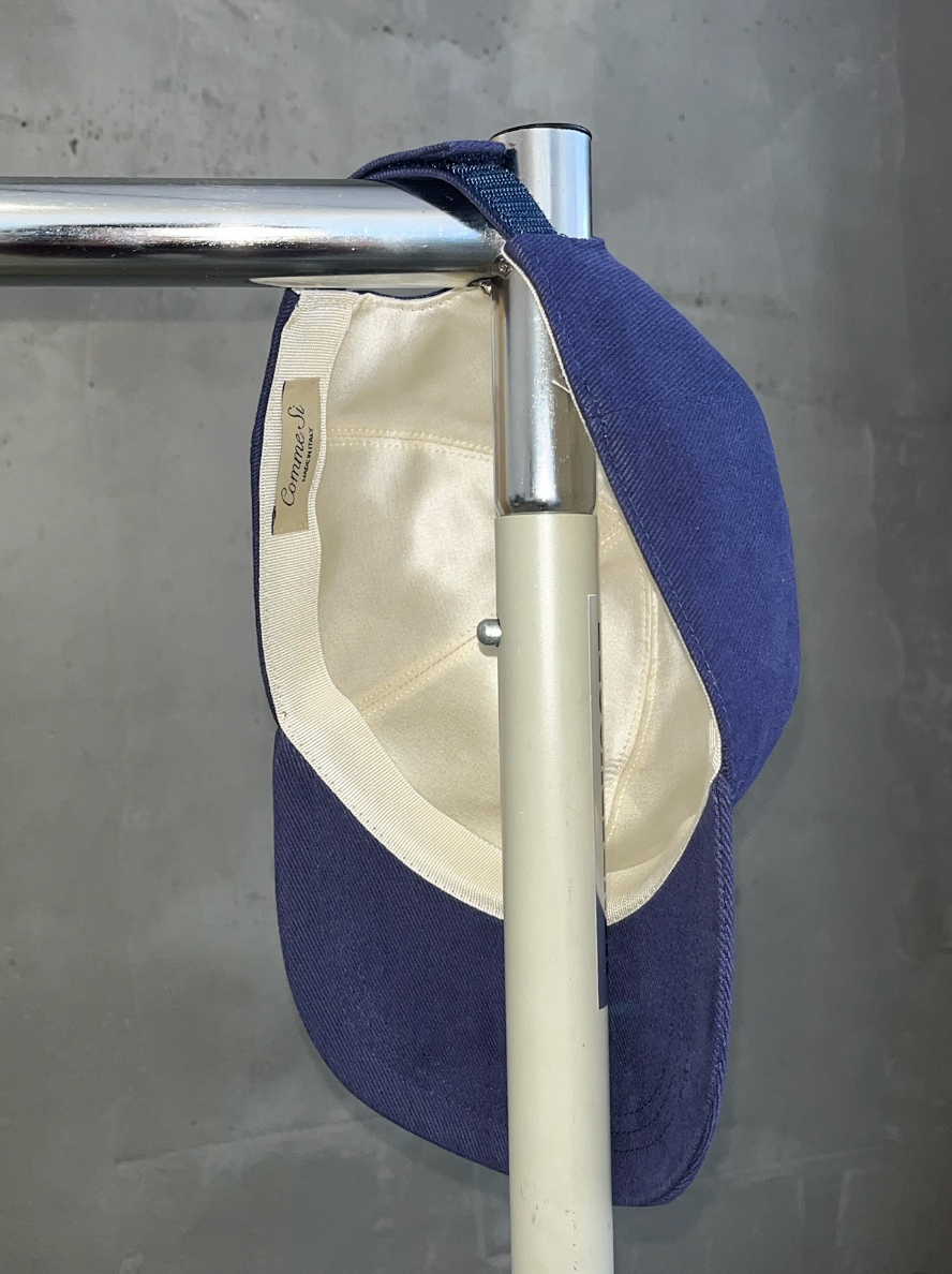 interior cream silk of The Silk-Lined Baseball Cap in Navy hanging on a clothing rack