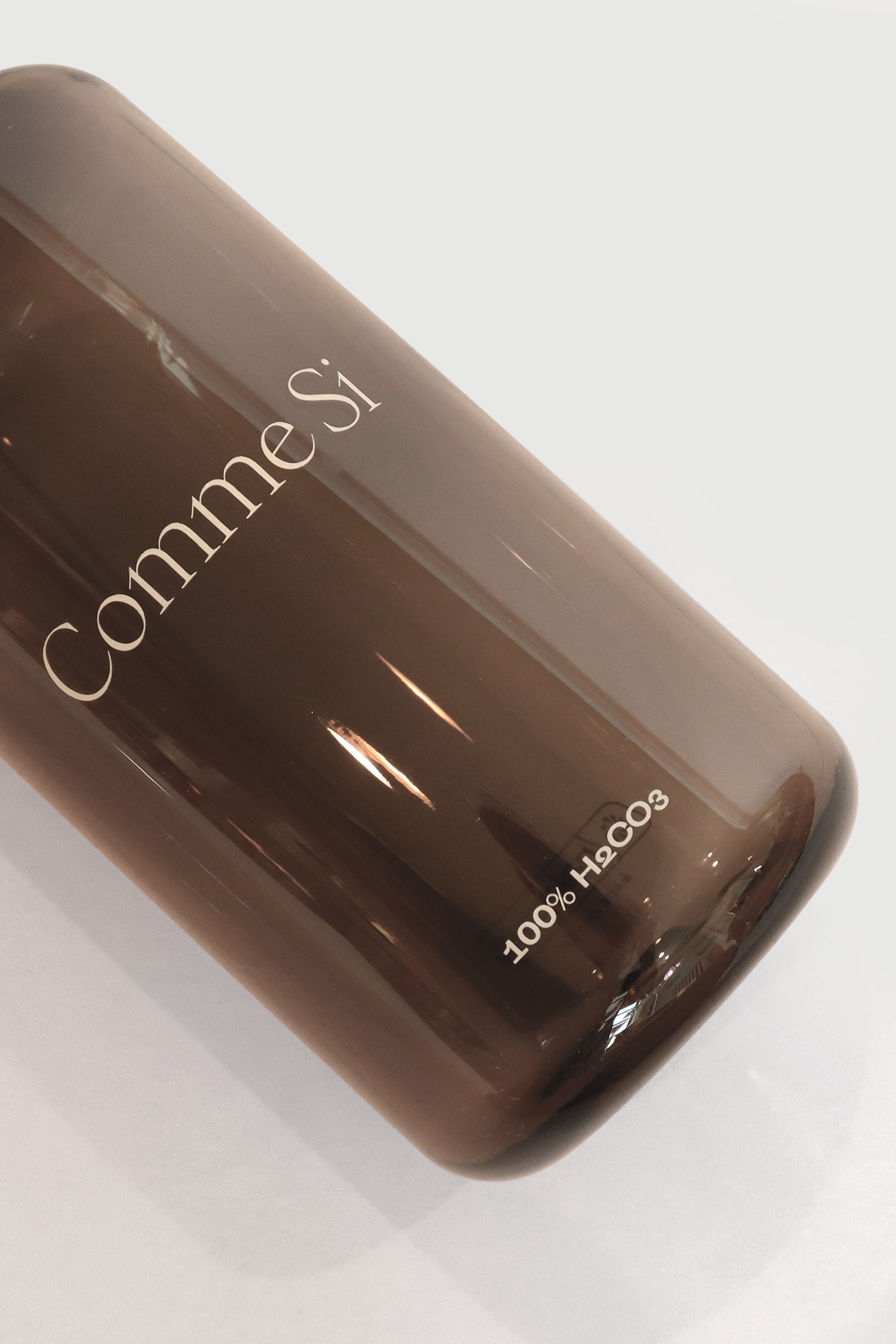 Front Design Detail - Comme Si Logo 100%H2CO3 - Dark Charcoal 32oz Nalgene bottle. Comme Si x Nalgene