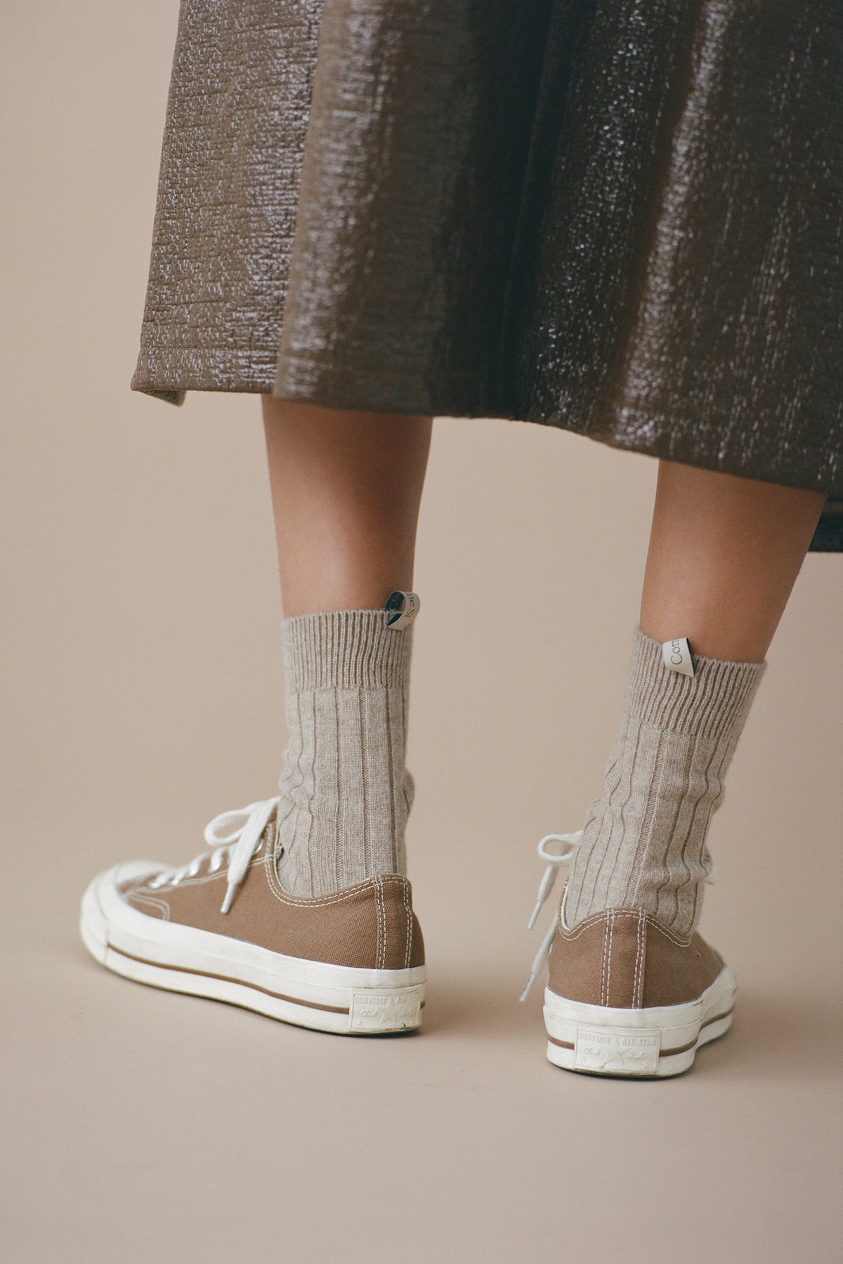 The Danielle Sock, Mongolian Cashmere, Oatmeal with brown Converse and a long Brown leather coat 