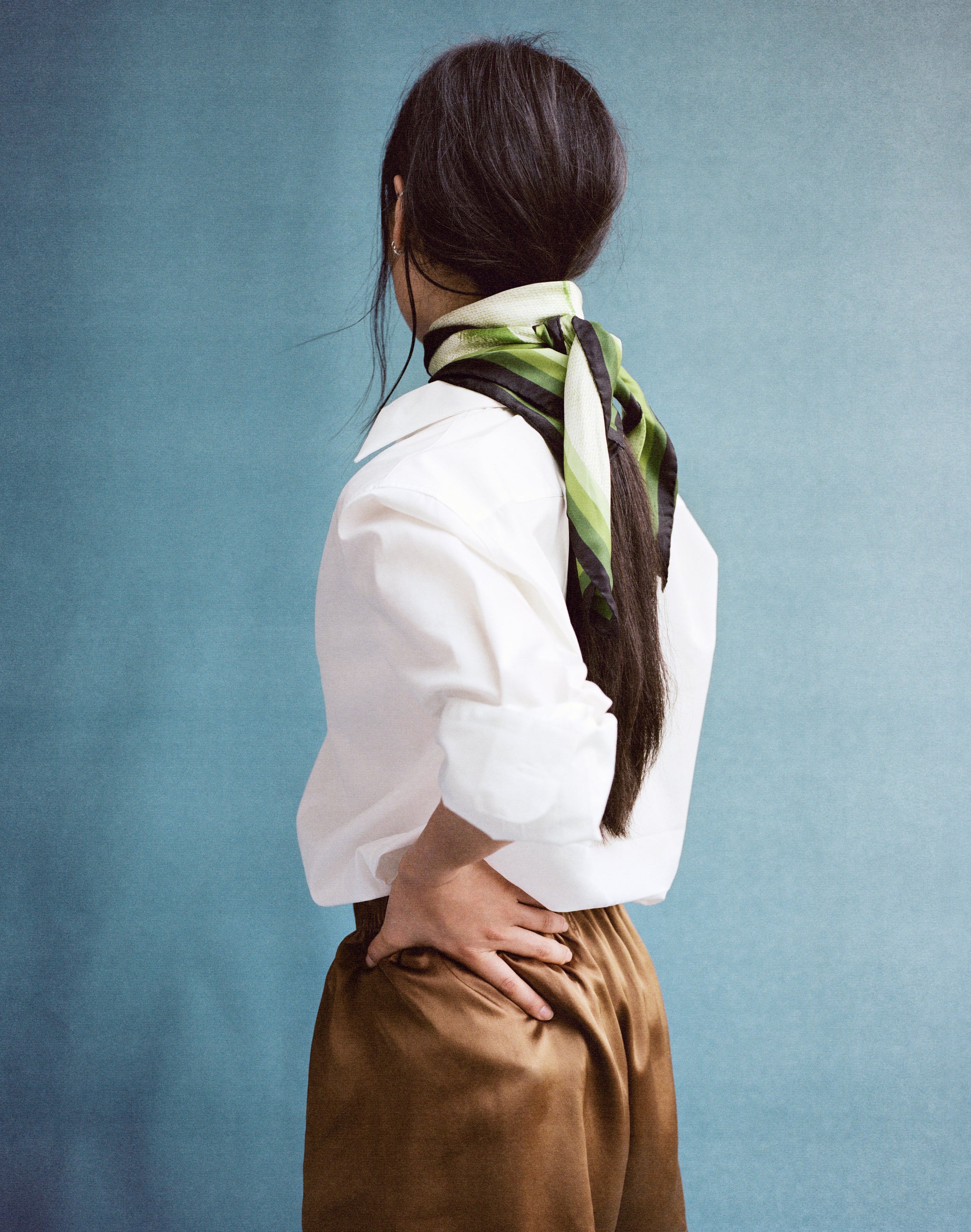 the silk scarf in green worn tied around the neck with white shirt and brown silk boxers