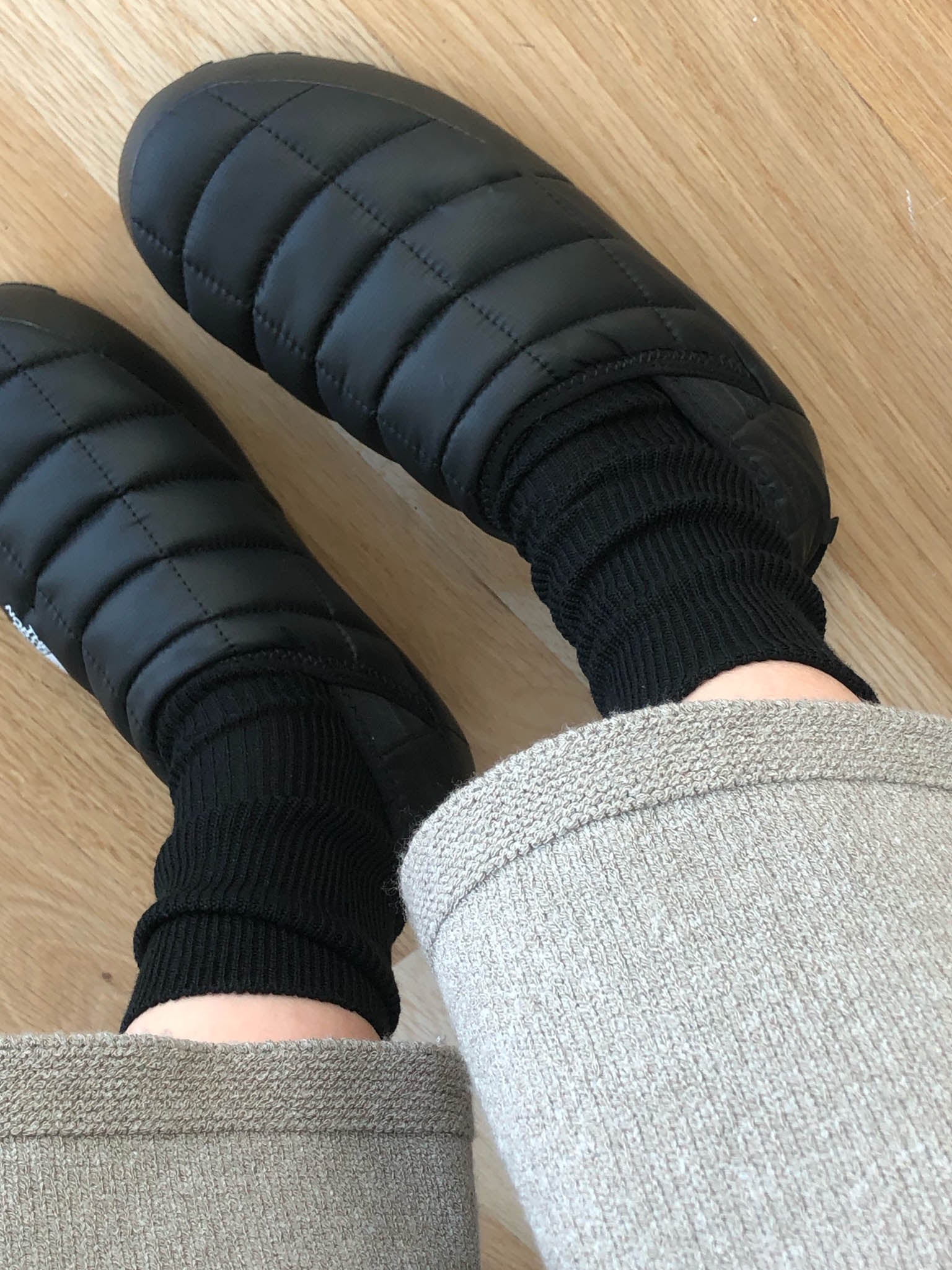 The merino sock in black with black insulated winter slippers